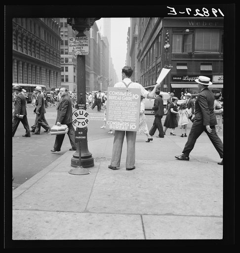42nd Street and Madison Avenue. Street hawker selling Consumer's Bureau Guide. New York City