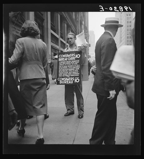 42nd Street and Madison Avenue. Street hawker selling Consumer's Bureau Guide. New York City