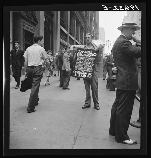 Untitled photo, possibly related to: 42nd Street and Madison Avenue. Street hawker selling Consumer's Bureau Guide. New York City