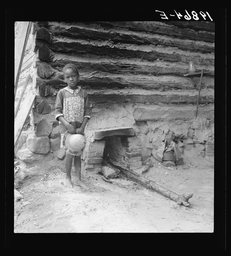 Untitled photo, possibly related to: Grandchildren of tobacco sharecropper down at barns. Note construction of tobacco sleds which have just been repaired by Zollie Lyons. Beyond them the screened platform in which that member of the family sleeps who tends the fire during the night. Wake County, No