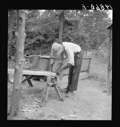 Zollie Lyons repairing the tobacco sleds at beginning of the harvest season. Wake County, North Carolina