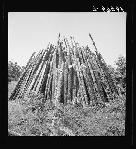 Piles of wood for firing the tobacco barns and curing the tobacco. These piles are characteristic of the landscape in tobacco country. Chatham County, North Carolina