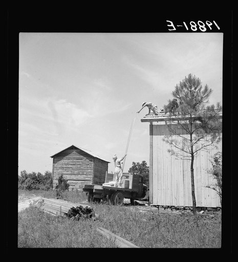 Building plank tobacco barn to replace old log one. Building takes approximately one week, this barn can be built for one hundred dollars. The average life of a barn is fifteen to twenty years. Near Chapel Hill, North Carolina