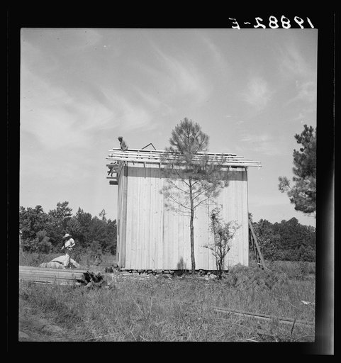 Untitled photo, possibly related to: Building plank tobacco barn to replace old log one. Building takes approximately one week, this barn can be built for one hundred dollars. The average life of a barn is fifteen to twenty years. Near Chapel Hill, North Carolina