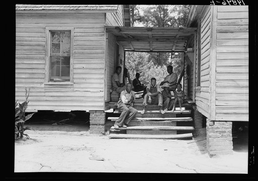 Untitled photo, possibly related to: Zollie Lyons, Negro sharecropper, home from the field for dinner at noontime, and part of his family. Upchurch, North Carolina. He has thirteen acres of tobacco and a labor force of five