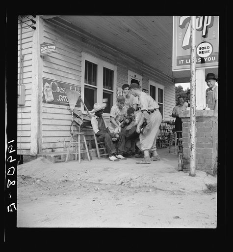 Untitled photo, possibly related to: Rural filling station becomes community center and general grounds for loafing. The men in baseball suits are on a local team which will play a game nearby. The team is called the Cedargrove Team. Fourth of July,  Near Chapel Hill, North Carolina