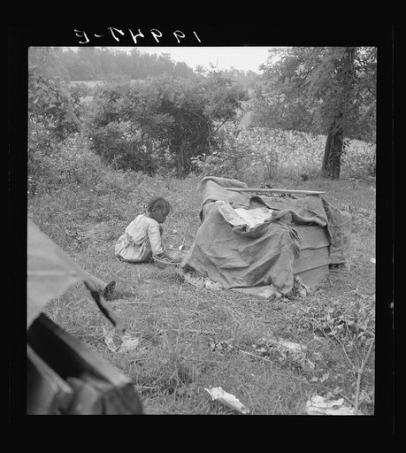 Tobacco sharecropper child playing. Note burlap covered playhouse. Person County, North Carolina
