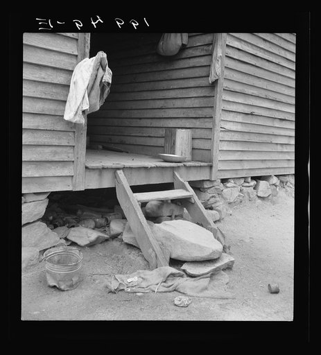 Untitled photo, possibly related to: Porch leading to kitchen of sharecropper cabin. They have been putting up strawberries. The sack which hangs on the side wall was used as a strainer Person County, North Carolina