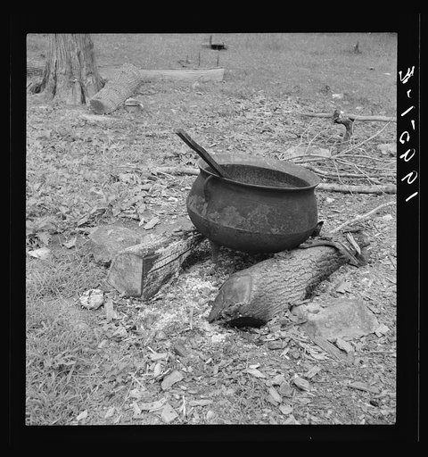 Iron pot for heating water stands out in the yard of Negro tobacco farmer. Person County, North Carolina