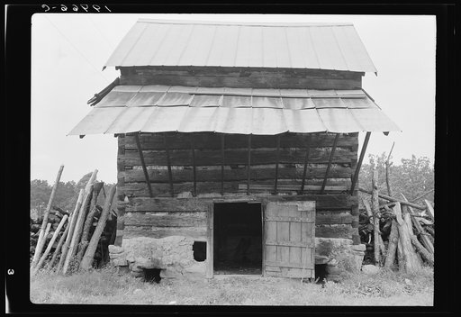 Tobacco barn with front shelter. Olive Hill, North Carolina