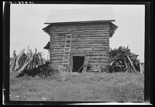 Untitled photo, possibly related to: Wood stacked up preliminary to firing the tobacco. Person County, North Carolina