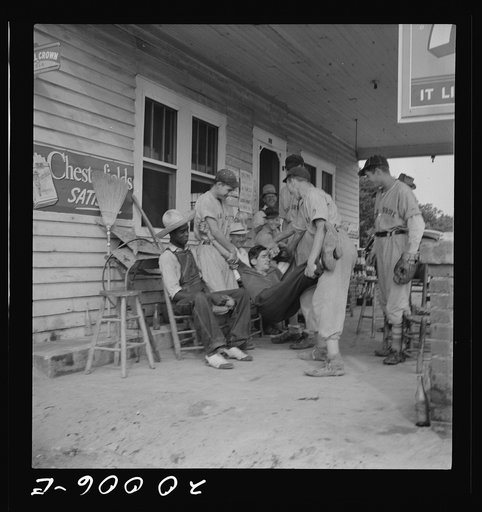 Untitled photo, possibly related to: Rural filling station becomes community center and general grounds for loafing. The men in baseball suits are on a local team which will play a game nearby. The team is called the Cedargrove Team. Fourth of July,  Near Chapel Hill, North Carolina
