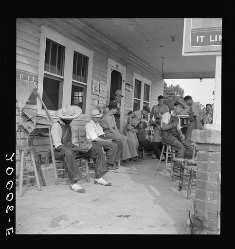 Rural filling station becomes community center and general grounds for loafing. The men in baseball suits are on a local team which will play a game nearby. The team is called the Cedargrove Team. Fourth of July, Near Chapel Hill, North Carolina