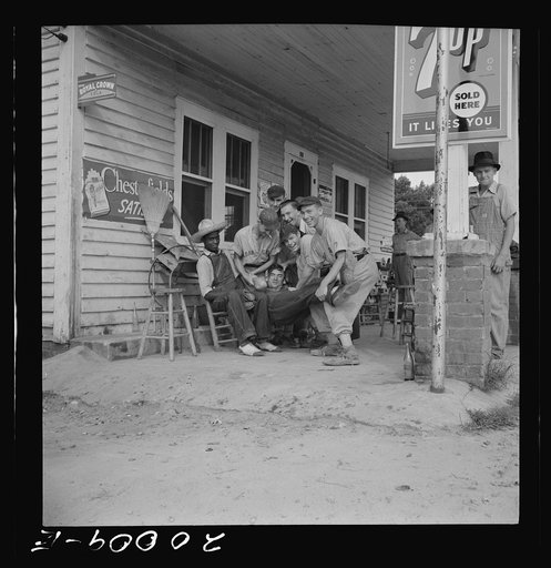 Untitled photo, possibly related to: Rural filling station becomes community center and general grounds for loafing. The men in baseball suits are on a local team which will play a game nearby. The team is called the Cedargrove Team. Fourth of July,  Near Chapel Hill, North Carolina