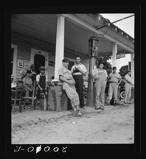Fourth of July, near Chapel Hill, North Carolina. Rural filling stations become community centers and general loafing grounds. The men in the baseball suits are on a local team which will play a game nearby. They are called the Cedargrove Team