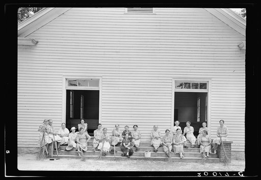 Women of the congregation of Wheeley's Church on steps with brooms and buckets on annual clean up day. Gordonton, North Carolina