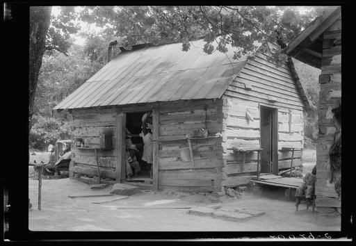 Double log cabin of Negro share tenants who raise tobacco. Family of eight has been on this place six or seven years. Person County, North Carolina