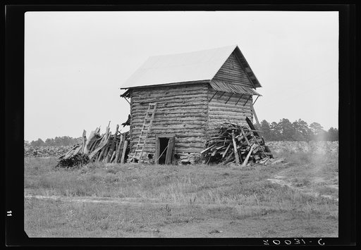 Tobacco barn without front shelter. The footpath across the field leads to the main house. Person County, North Carolina