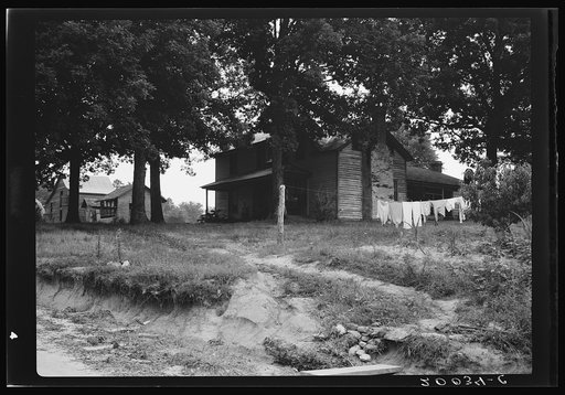 Untitled photo, possibly related to: The one-and-a-half story part of this house was built fifty to sixty years ago. The two-story part was built in 1900. Farm is owned by a woman whose husband died seventeen years ago. Person County, North Carolina