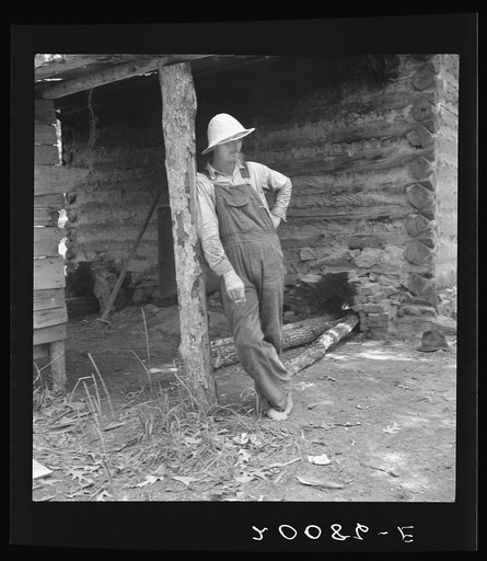 Mr. Taylor, tobacco sharecropper, relaxes when the tobacco has been "put up." Granville County, North Carolina