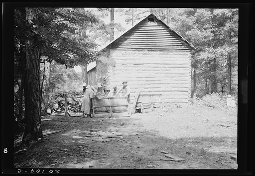 Untitled photo, possibly related to: Families stringing tobacco brought in from the field by sled. Granville County, North Carolina