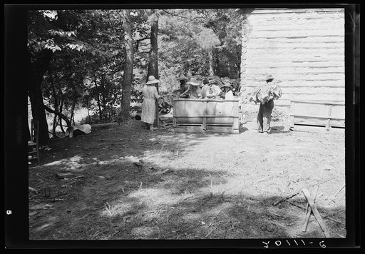 Untitled photo, possibly related to: Families stringing tobacco brought in from the field by sled. Granville County, North Carolina