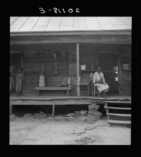 Untitled photo, possibly related to: Porch of Negro tenant house, showing household equipment. Person County, North Carolina