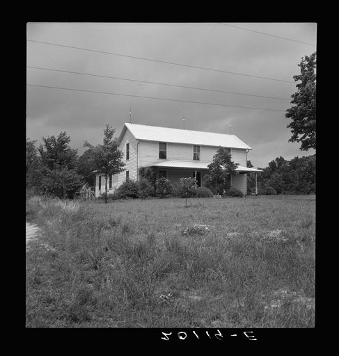 Substantial looking tobacco farm. Note galvanized imitation shingle roof. Person county, North Carolina