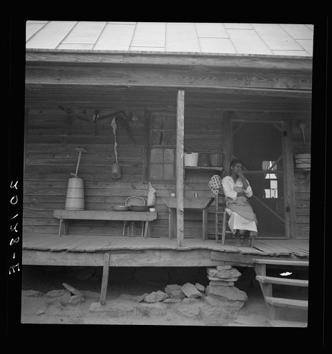 Porch of Negro tenant house, showing household equipment. Person County, North Carolina