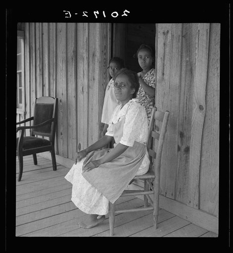 Wife of tenant farmer with two of her six children, none of whom go to school. Chatham County, North Carolina