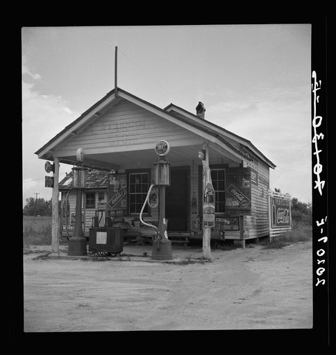 Country filling station owned and operated by tobacco farmer. Such small independent stations have become meeting places and loafing spots for neighborhood farmers in their off times. Granville County, North Carolina
