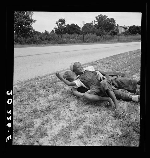 Untitled photo, possibly related to: White and Negro boy wrestling by side of road. Person County, North Carolina