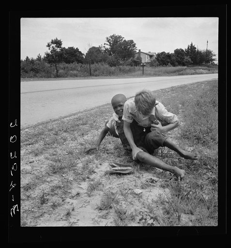 White and Negro boy wrestling by side of road. Person County, North Carolina