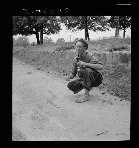 Untitled photo, possibly related to: Roadside meeting with Durham County farmer. North Carolina. He gives road directions by drawing the dirt with a stick