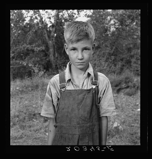 Migratory boy in squatter camp. Has come to Yakima Valley for the third year to pick hops. Mother: "You'd be surprised what that boy can pick." Washington, Yakima Valley