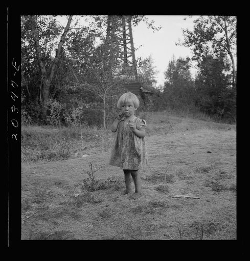 Migratory child in squatter camp before hop season opens. Her little brothers work in the field. Washington, Yakima Valley