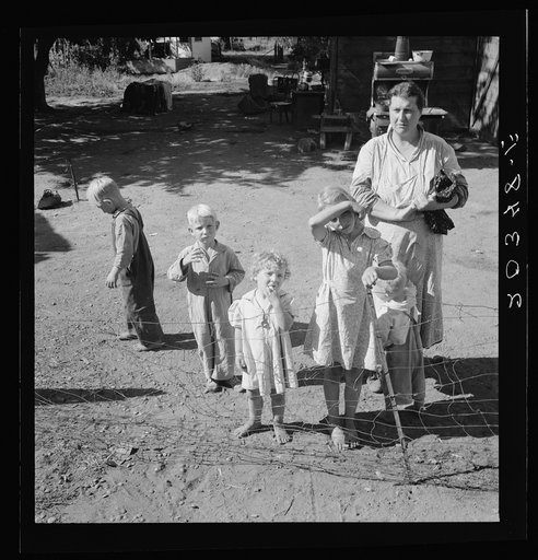 Untitled photo, possibly related to: Family living in shacktown community, mostly from Kansas and Missouri. This family has five children, oldest in third grade. Rent seven dollars per month, no plumbing. Husband working on Work Projects Administration wages, forty four dollars