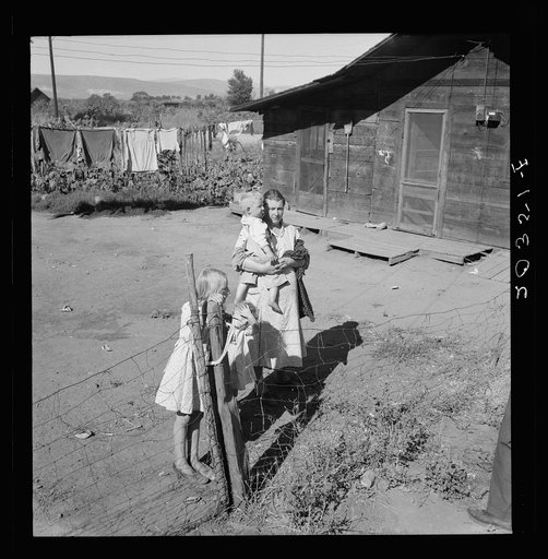 Untitled photo, possibly related to: Family living in shacktown community, mostly from Kansas and Missouri. This family has five children, oldest in third grade. Rent seven dollars per month, no plumbing. Husband working on Work Projects Administration wages, forty four dollars