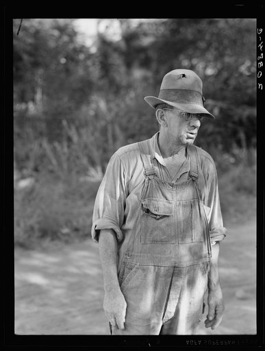 Untitled photo, possibly related to: Migratory worker in auto camp. Single man, speaks his mind. "Them WPAs are keeping us from a living. They oughtn't to do it. It ain't fair in no way. The government lays them off (that is in Work Projects Administration - 1939) and they come in because they're lo