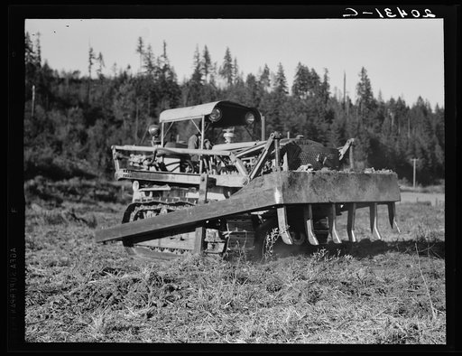 Untitled photo, possibly related to: Western Washington, Lewis County. Bulldozer raises and pushes stump on cut-over farm