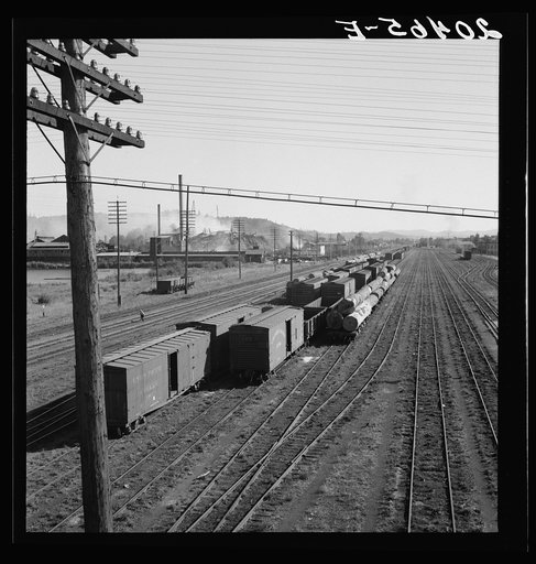 Washington, Lewis County, Centralia. Railroad yard, looking down from highway bridge. Disaster to the town: the one remaining lumber mill burned down a week before. (Note smoke and wreckage)