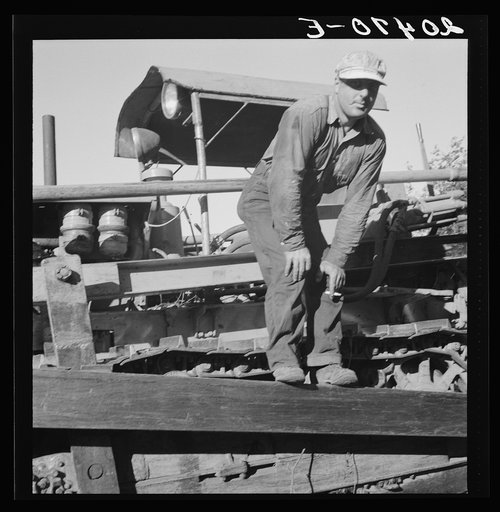 Untitled photo, possibly related to: Western Washington, Lewis County. Bulldozer raises and pushes stump on cut-over farm