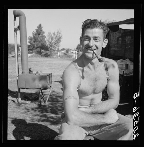 Untitled photo, possibly related to: Unemployed lumber worker goes with his wife to the bean harvest. Note social security number tattooed on his arm. Oregon. See general caption number 46