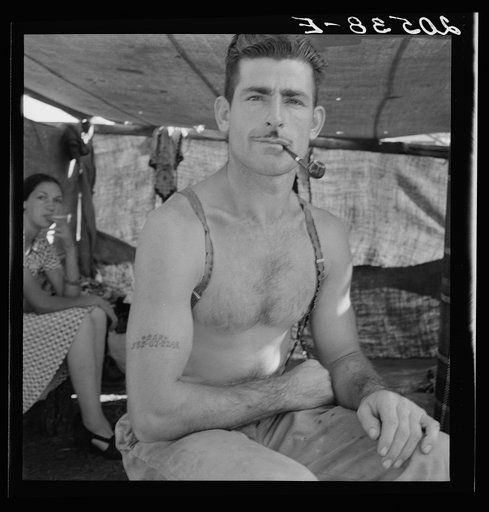 Untitled photo, possibly related to: Unemployed lumber worker goes with his wife to the bean harvest. Note social security number tattooed on his arm. Oregon. See general caption number 46