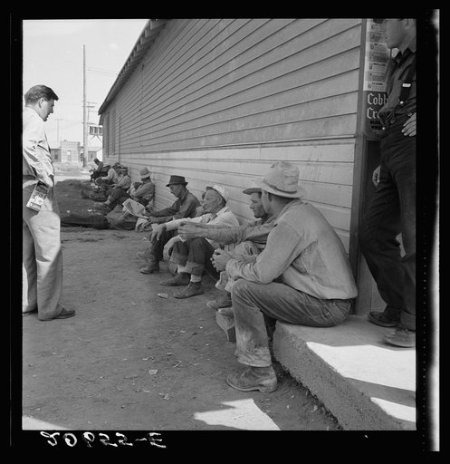 Untitled photo, possibly related to: Idle men seated in shade on the other side of Pastime Cafe, three weeks before opening of Klamath Basin potato harvest. California, Siskiyou County, Tulelake. See general caption number 43