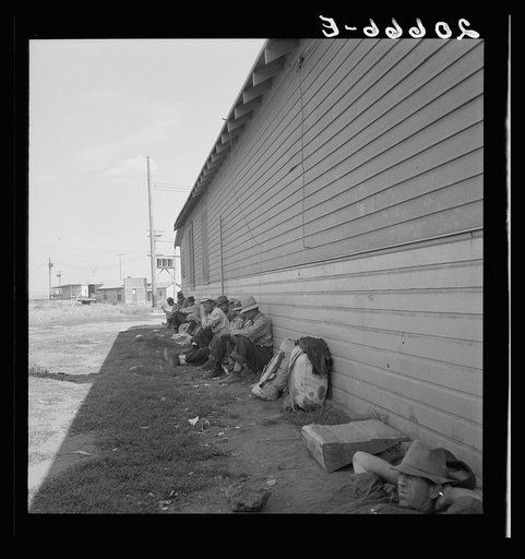 Untitled photo, possibly related to: Idle men seated in shade on the other side of Pastime Cafe, three weeks before opening of Klamath Basin potato harvest. California, Siskiyou County, Tulelake. See general caption number 43