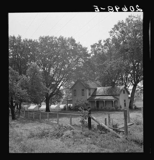 Hop grower's home on Rogue River, with the tent camp he provides for his pickers beyond. Oregon, Josephine County, near Grants Pass. See general caption number 45-11