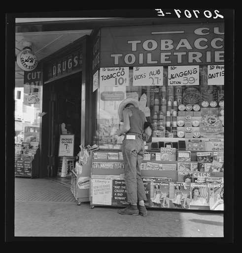 Oregon. Medford. Half-grown farm boy on main drugstore corner in town