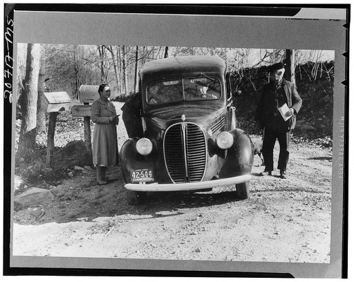 Some residents of Ledyard, Connecticut, receiving their mail from mail carrier at crossroads
