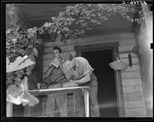 Oregon. Independence, Polk County. Hop farmer's sons, washing for noon meal on back porch. They supervise the migratory workers in the field and tend to the weighing of hops